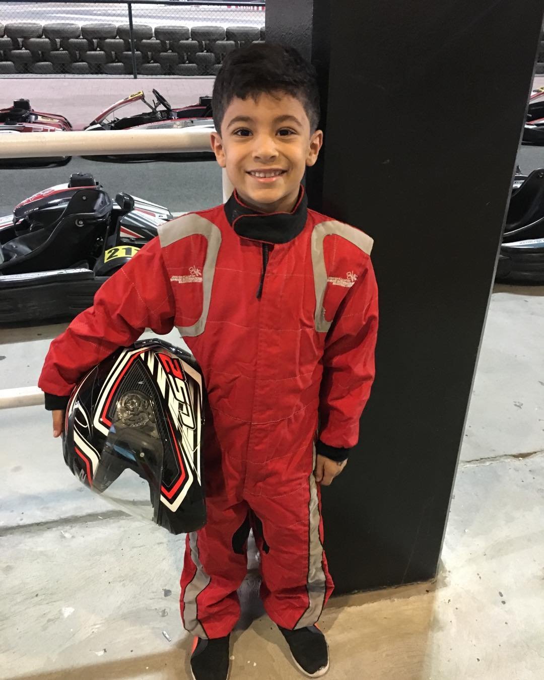Young Khalid Al-Najjar in his first race suit, holding his helmet
