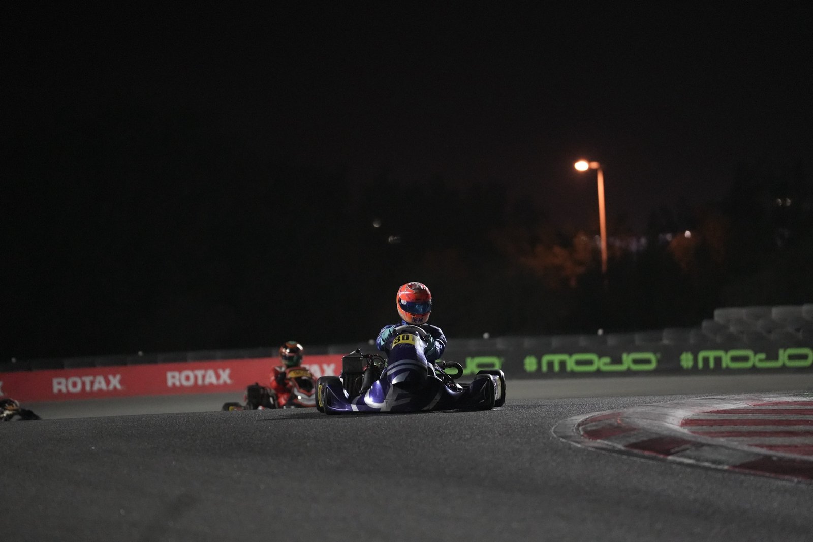 Karts racing under floodlights at the Bahrain International Karting Circuit