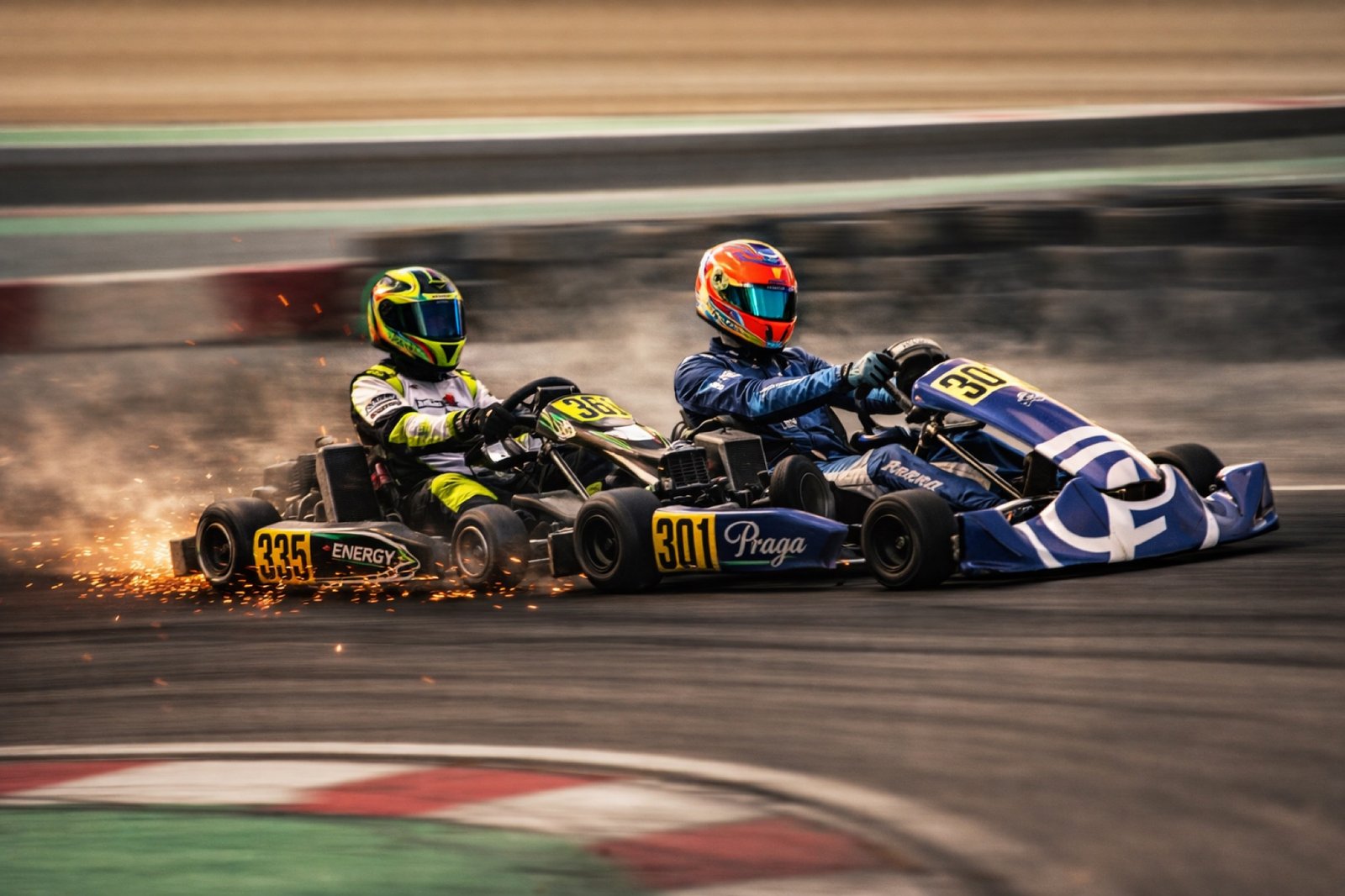 Khalid's number 301 Praga running wheel-to-wheel with a rival kart, sparks flying from the track