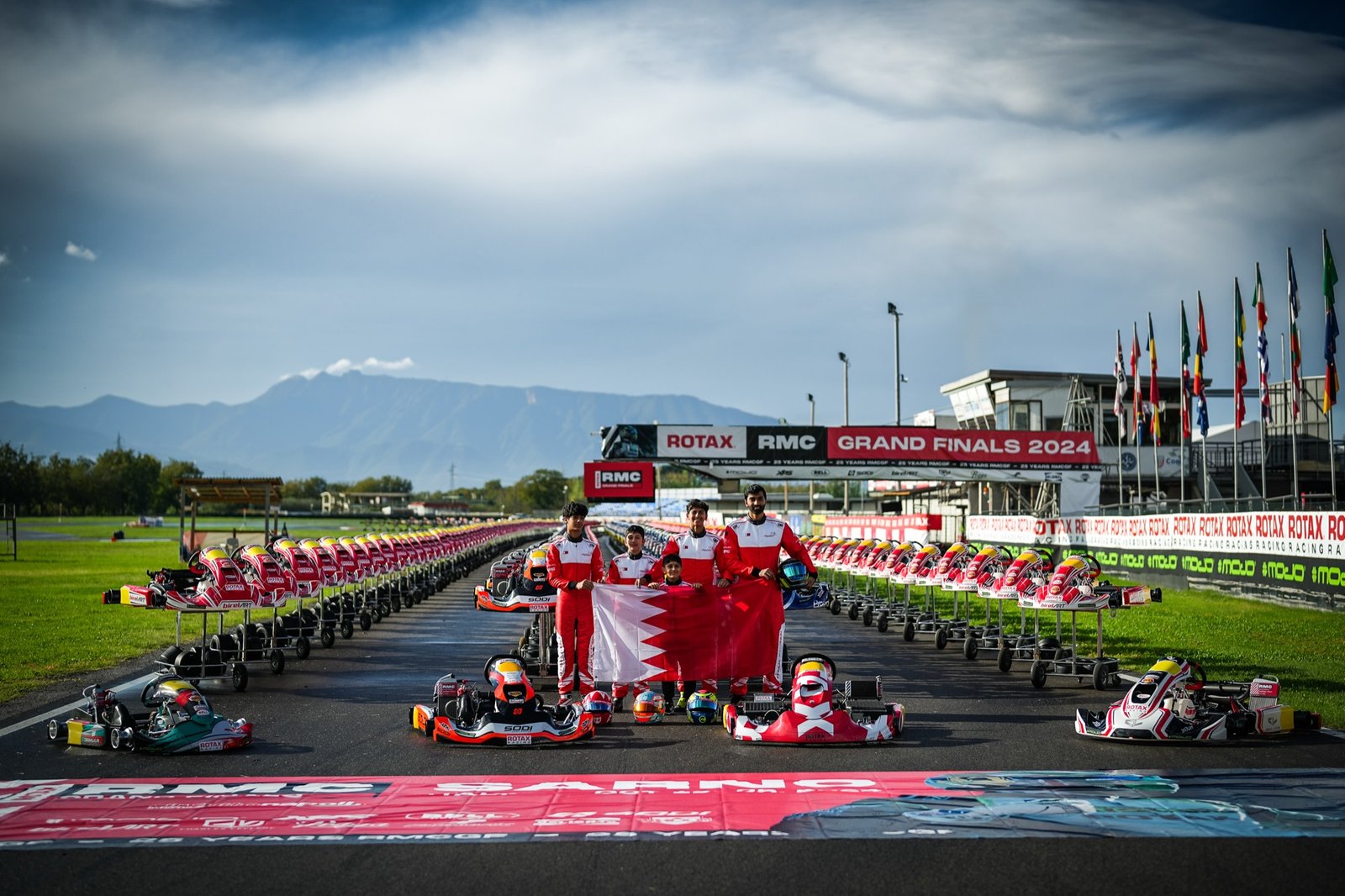Khalid and the Bahrain team holding the national flag on the Rotax Grand Finals grid at Sarno, Italy