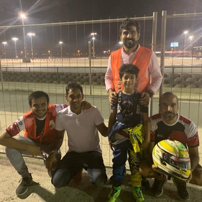 Six-year-old Khalid with his first coaches at the Bahrain International Karting Circuit at night