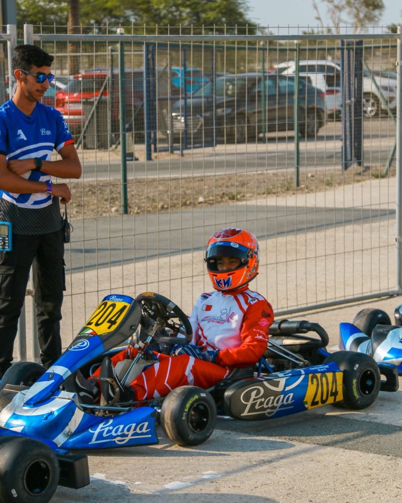 Khalid seated in his number 204 Praga kart in the BIKC paddock