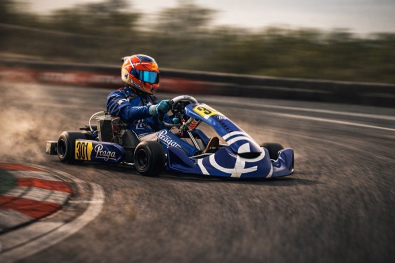 Khalid's number 301 Praga kart in a golden-hour panning shot at speed